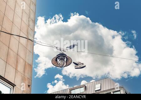 shoes on a power line wire in the city, a raven bird Stock Photo