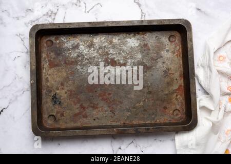 empty metal rectangular baking sheet on a white table Stock Photo
