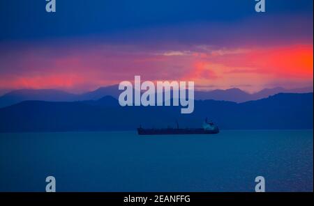 transport ship at sunset in the Avacha Bay on the Kamchatka Peninsula Stock Photo