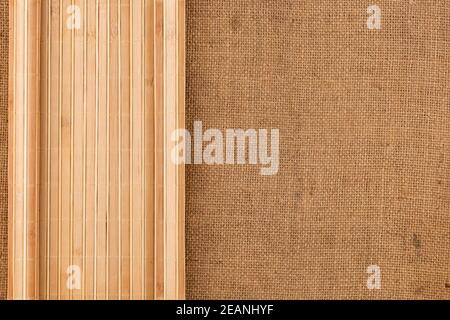 Bamboo mat twisted in the form of a manuscript on sackcloth Stock Photo