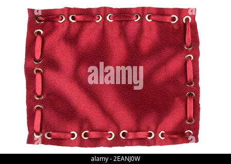 Frame made of red silk with inserted  satin ribbon in gold rings Stock Photo