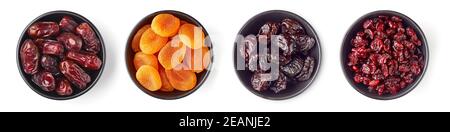 Bowl of dried apricots, cranberries, dates and prunes isolated on white background; top view Stock Photo