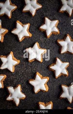 Icing gingerbread stars. Traditional Christmas cookies. Stock Photo