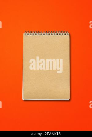 Spiral closed notebook mockup on red background Stock Photo