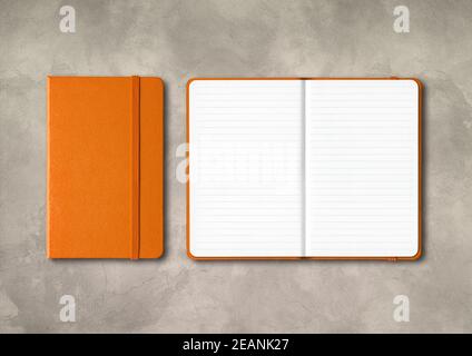 Orange closed and open lined notebooks on concrete background Stock Photo