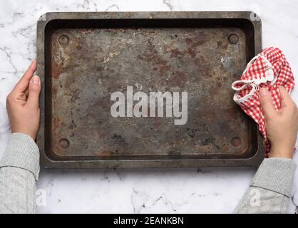 empty metal rectangular baking sheet on a white table, top view Stock Photo