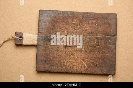 empty old brown rectangular wooden cutting board, brown background Stock Photo