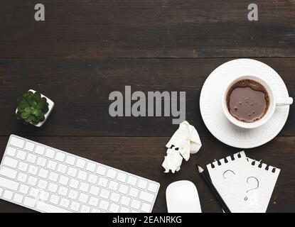 white wireless keyboard and mouse on a wooden brown table Stock Photo