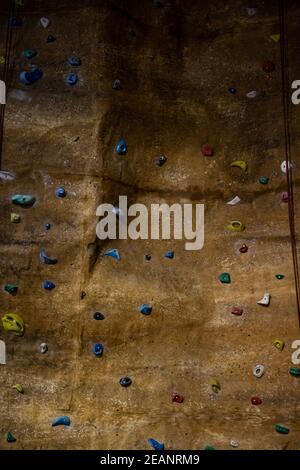 climbing wall with different colored handles in a modern gym Stock Photo
