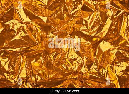 Abstract background of golden crumpled plastic Stock Photo