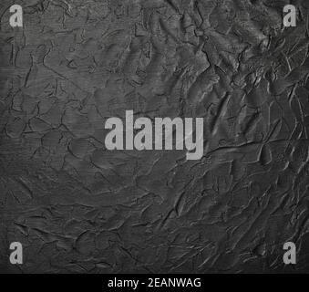 Black uneven grunge surface abstract background Stock Photo