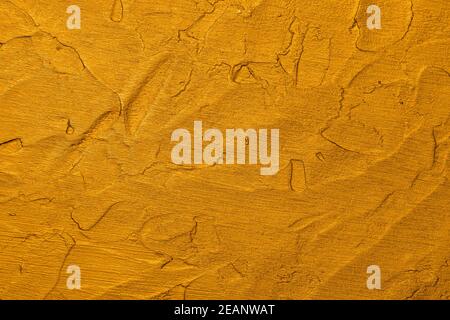 Golden uneven grunge surface abstract background Stock Photo