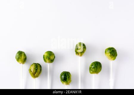 Set of brussel sprouts with lollipop sticks isolated on white background. Copy space Stock Photo