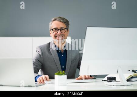 Happy Professional Man Employee Using Computer Stock Photo