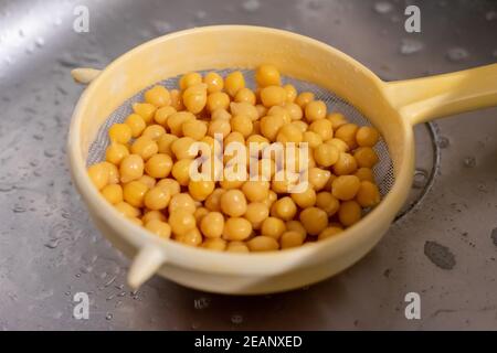 canned chickpeas in a kitchen colander Stock Photo