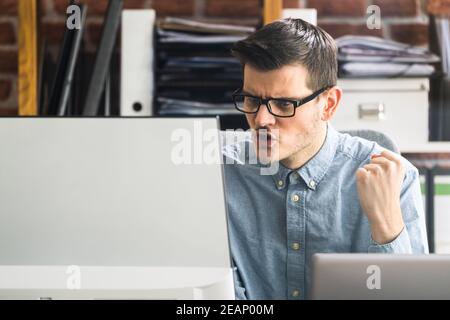 Workplace Quarrel. Angry Looking Man Stock Photo