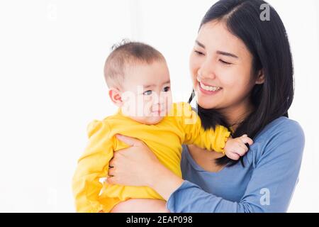 mother holding his newborn little baby in her arms Stock Photo