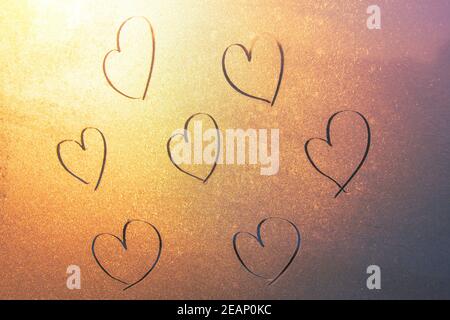 Several hearts by hand drawn on frozen glass, pattern. Love concept, Valentine's Day Stock Photo