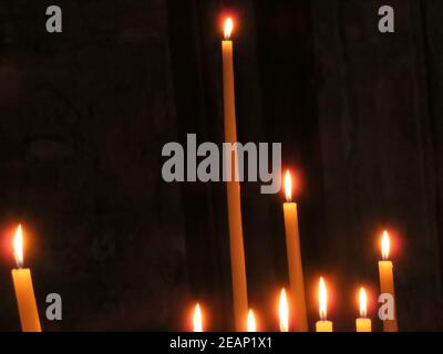Beautiful photo of candles in a church lit for the feeling Stock Photo