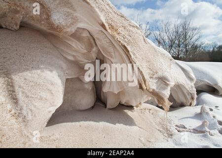 Snowdrift, a deposit of snow and some sand sculpted by wind into a mound during a snowstorm Stock Photo