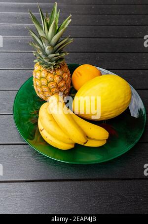 Assortment of fresh exotic fruits on  black table Stock Photo