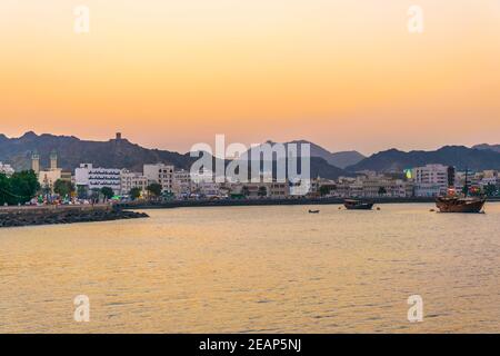 View of coastline of Muttrah district of Muscat during sunset, Oman. Stock Photo