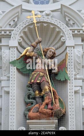 Saint Michael slaying the dragon, statue on the portal of the church of St. Leodegar in Lucerne, Switzerland Stock Photo