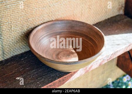 clay dish on the shelf. Shelves with standing on their utensils of porcelain and earthenware. Vintage kitchen utensils Stock Photo