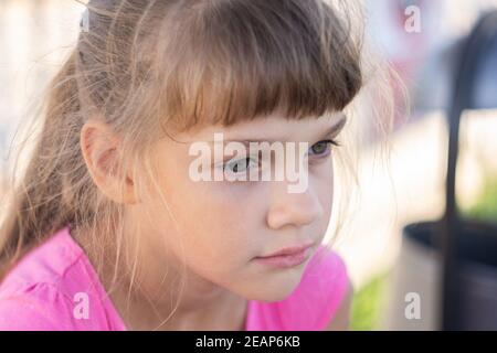 Portrait of a pensive European girl eight years old Stock Photo