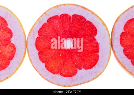Fruit slices of red grapefruit isolated on white background, close up Stock Photo