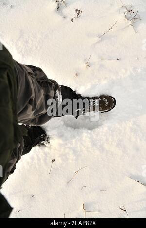 The hunter walks in the snow in a shoe resistant to snow and ice Stock Photo