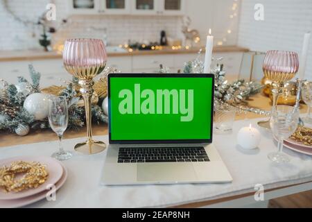 laptop with green screen - chromakey near New Year's decorations. christmas theme. Stock Photo