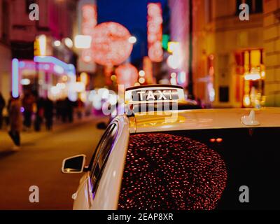 Taxi car during night in the city of Vienna, Austria Stock Photo