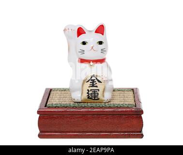 Japanese lucky cat isolated on white background, Japanese word of this photography means 'economic fortune' Stock Photo