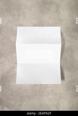 Blank folded White A4 paper sheet mockup template on concrete background Stock Photo