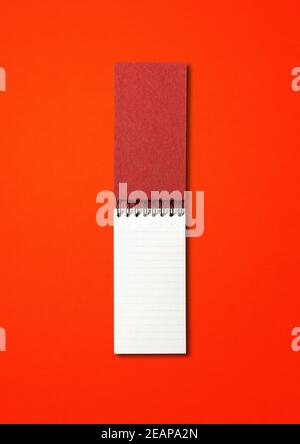 Blank open spiral notebook isolated on red Stock Photo