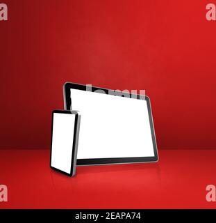 Mobile phone and digital tablet pc on red office desk Stock Photo