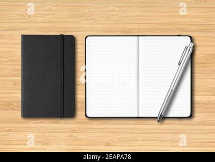 Black closed and open lined notebooks with a pen on wooden background Stock Photo
