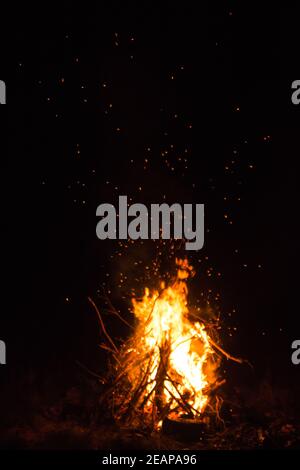 Firecamp at the night time. Hot fireplace full of wood and fire burning, closeup Stock Photo