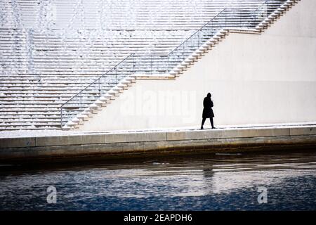 Berlin, Berlin, Germany. 10th Feb, 2021. A single person walks through snow in the government district of central Berlin. A weather phenomenon called the polar vortex split brought snow and icy winds to Berlin and Brandenburg with temperatures well below freezing. Credit: Jan Scheunert/ZUMA Wire/Alamy Live News