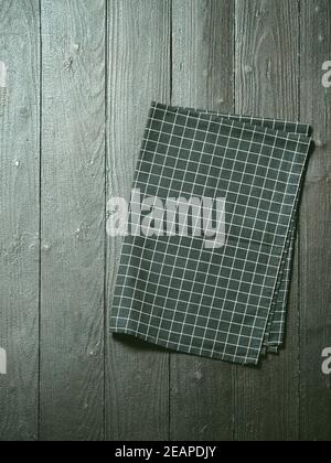 Gray wooden table with kitchen napkin, flat lay Stock Photo