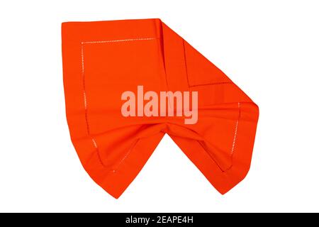 Closeup of a orange napkin or tablecloth isolated on white background. Kitchen accessories. Stock Photo