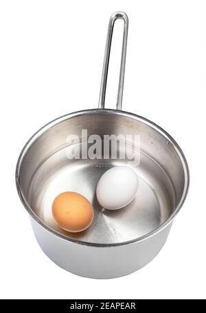 front view of two eggs in saucepan with water Stock Photo