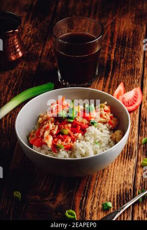 Scrambled eggs with tomatoes, leek and white rice Stock Photo