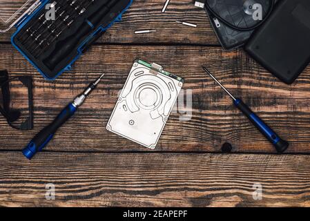 HDD with Precision Screwdriver on Wooden Table Stock Photo