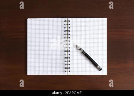 Top view of blank notepad on wooden desk Stock Photo