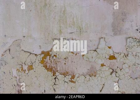 The wall of a building with peeling paint. Stock Photo