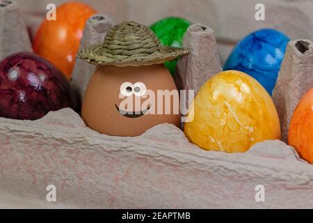 Egg with a funny face in the packaging Stock Photo