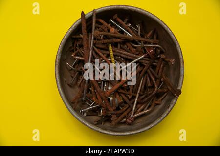 metal rusty nails on a yellow background Stock Photo