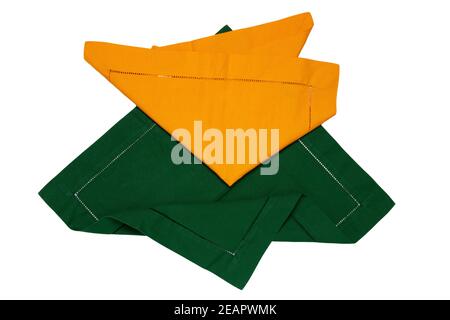 Closeup of a green and a yellow napkin or tablecloth isolated on white background. Kitchen accessories. Stock Photo